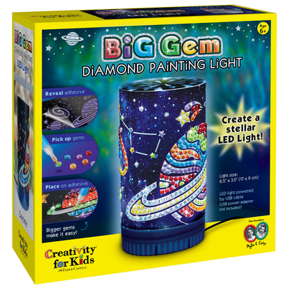 Big Gem Diamond Painting Light kit box showing cylindrical LED light with colorful gem-decorated space and planet design, includes reveal adhesive, pick-up gems