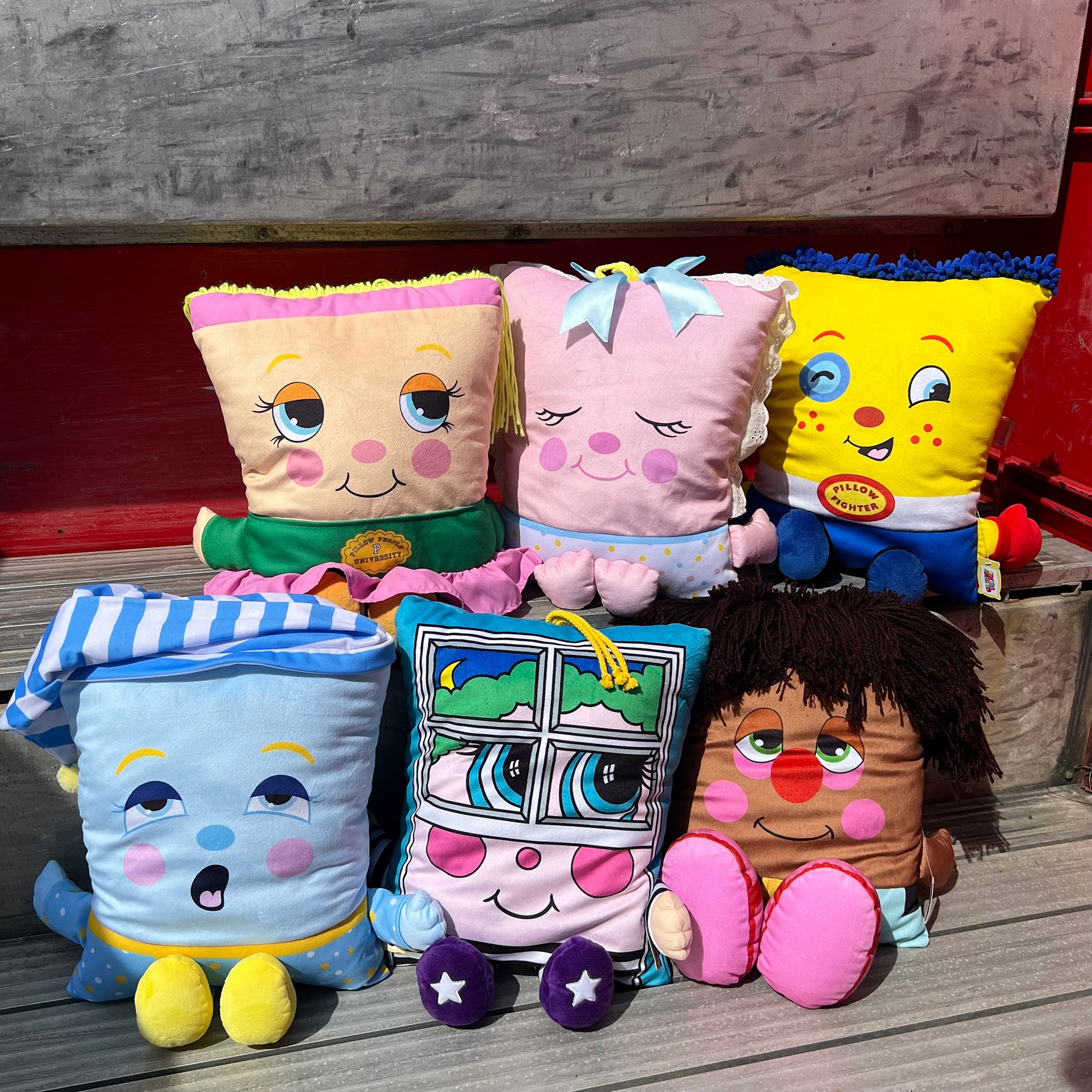 Pillow People PJ Sandman plush toys and pillows in colorful designs including yellow, pink, and blue characters