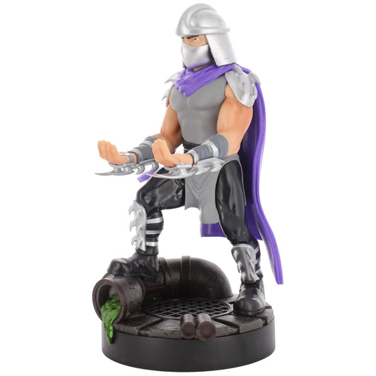 Shredder action figure with silver helmet, purple cape, gray and black armor, holding sai weapons, standing on dark base