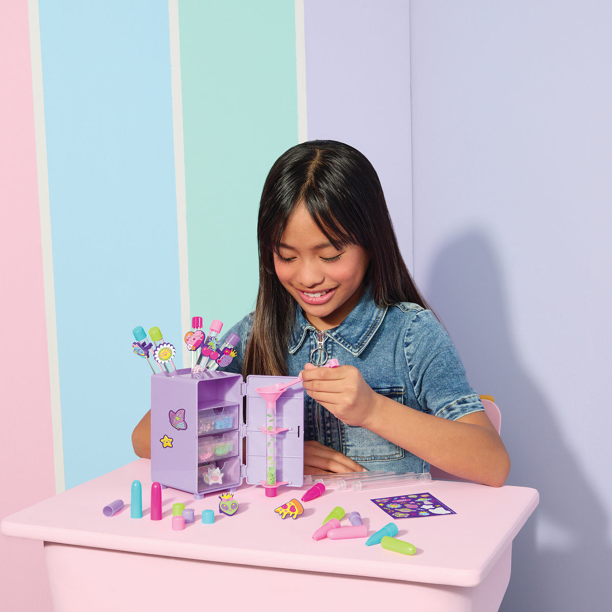 Girl creating floaty character pens with Make It Real Write in Style Pen Creation Station purple storage locker craft...