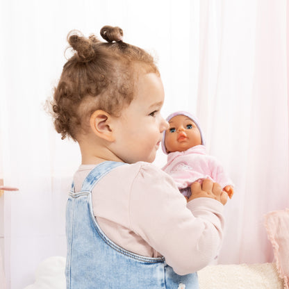 My First Baby Doll 11 inch pink rainbow outfit held by toddler