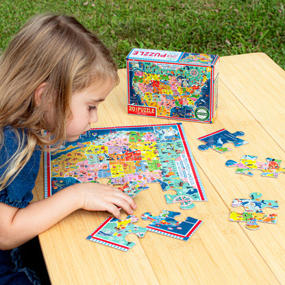 Child assembling colorful USA Map 20 Piece Puzzle on wooden table