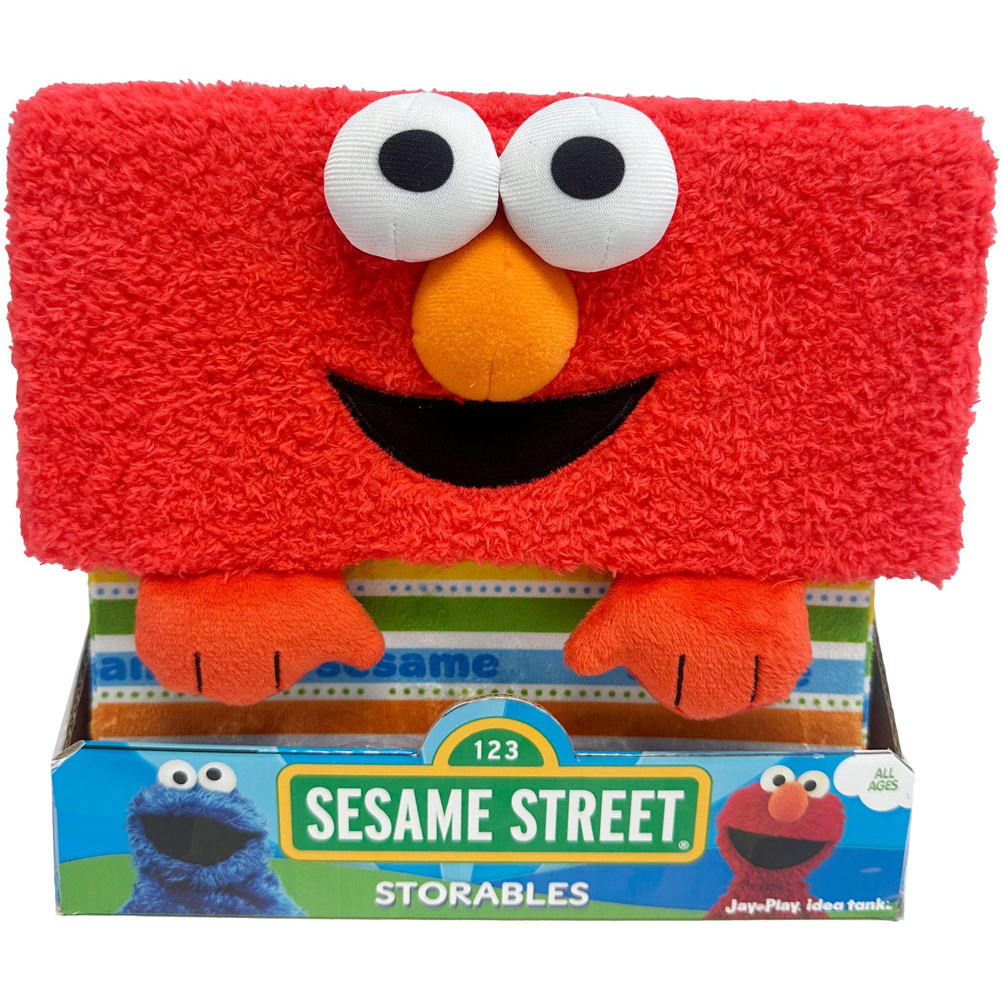 Sesame Street Elmo Storables fabric storage bin, red plush with white eyes, orange nose, black smile, and orange paws, shown in packaging