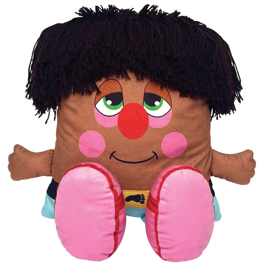 Pillow People plush doll with brown body, black yarn hair, green eyes, red clown nose, pink cheeks, smiling face, and large pink padded feet