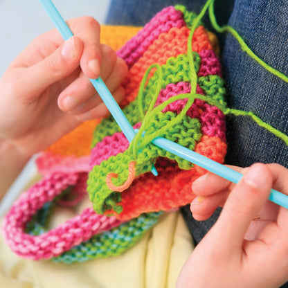 Easy-To-Do Knitting toy with colorful pink, green, and orange knitted fabric and blue needle