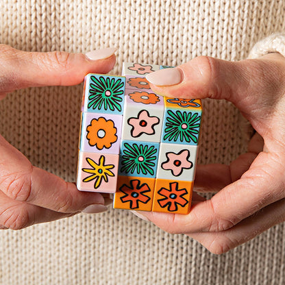 JOS Art Cube Flower Pop toy with colorful flower designs in green, orange, and pink