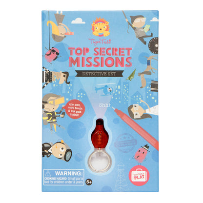 Tiger Tribe Top Secret Missions Detective Set box featuring spy-themed illustrations, lion logo, and red magnifying glass torch attachment on blue background