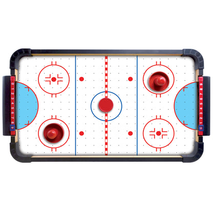 Tabletop air hockey game with white playing surface, red and blue goals, two red puck strikers, and black frame with handles