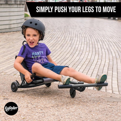 Child riding black EzyRoller Classic leg-powered scooter on pavement