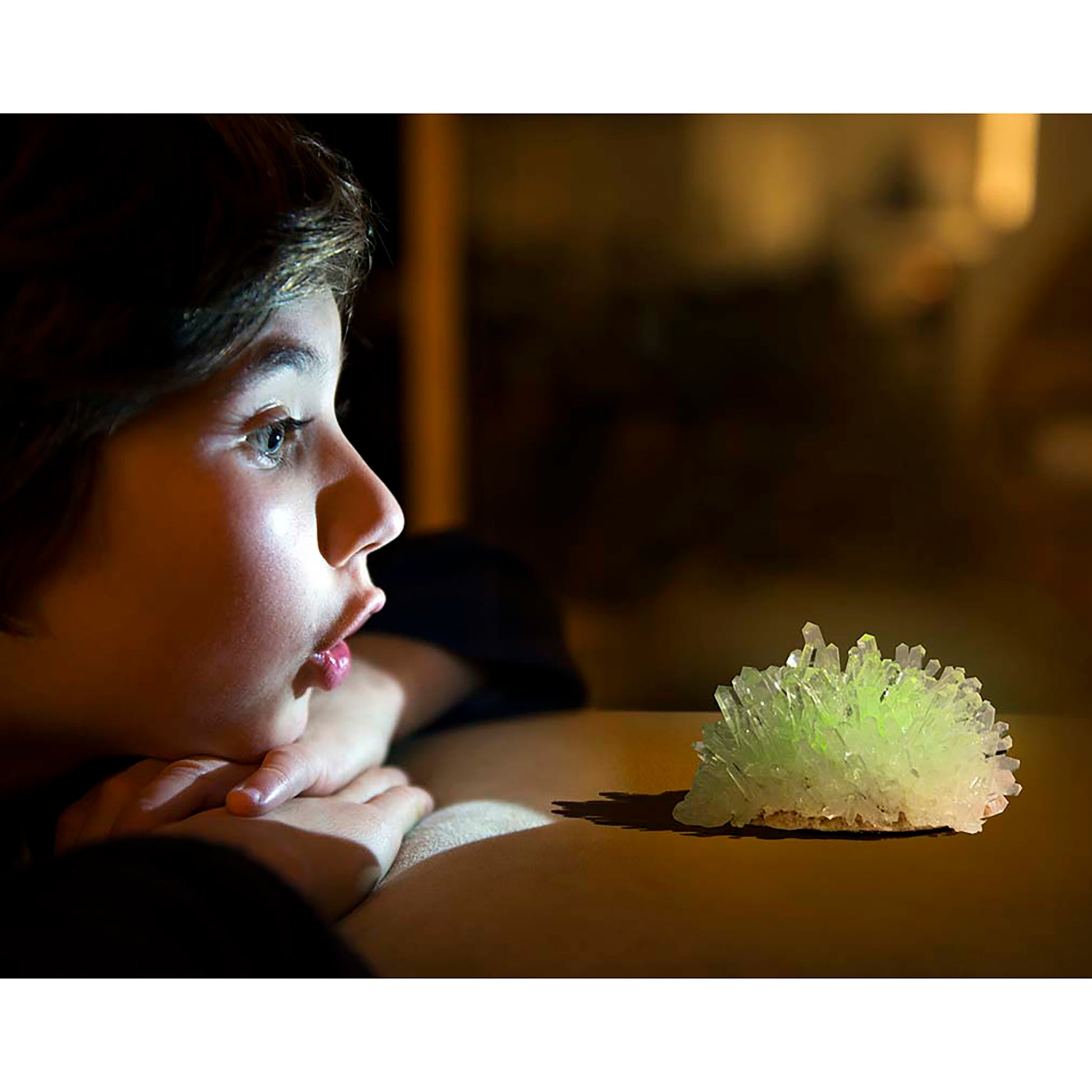 Glow Crystal Growing kit with luminescent green crystal displayed on wooden surface