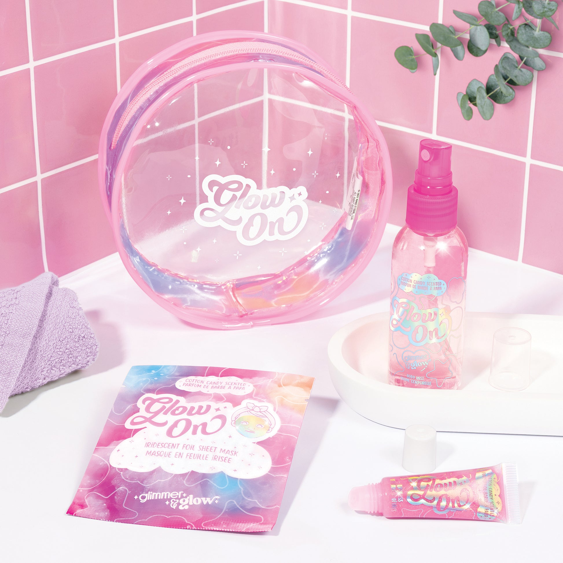 Glimmer & Glow beauty bag set with pink mist, sheet mask, lip gloss and clear case