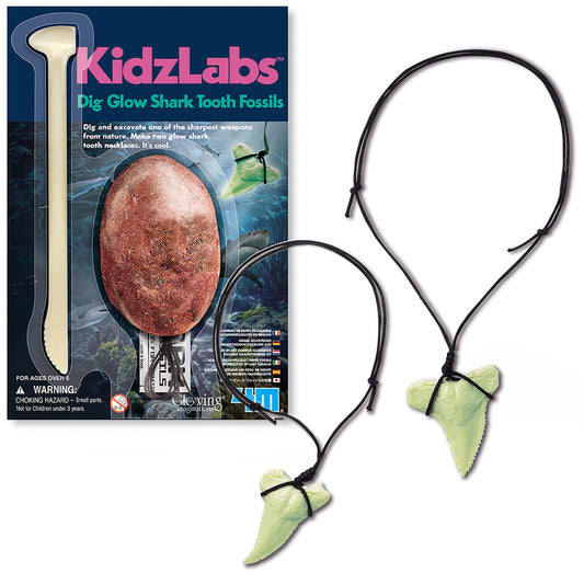 KidzLabs Dig Glow Shark Tooth Fossils kit with excavation tool, brown fossil egg, and two glow-in-the-dark green shark tooth necklaces