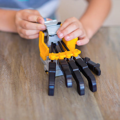 KidzRobotix Motorized Robot Hand with yellow and black articulated fingers