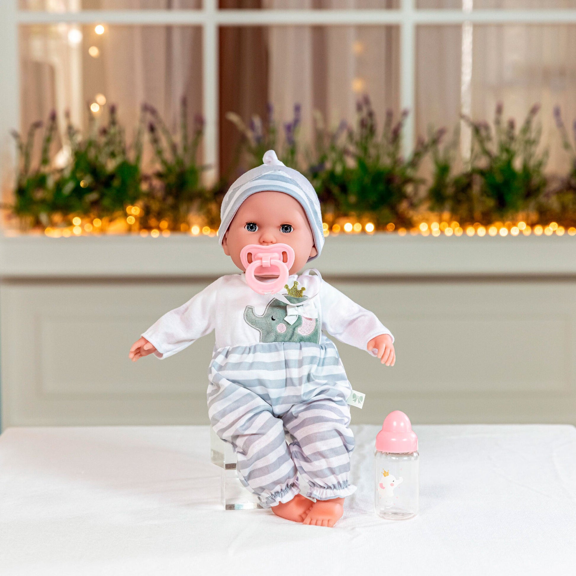 JC Toys Nonis Boutique 15" baby doll in grey striped outfit with bottle and pacifier