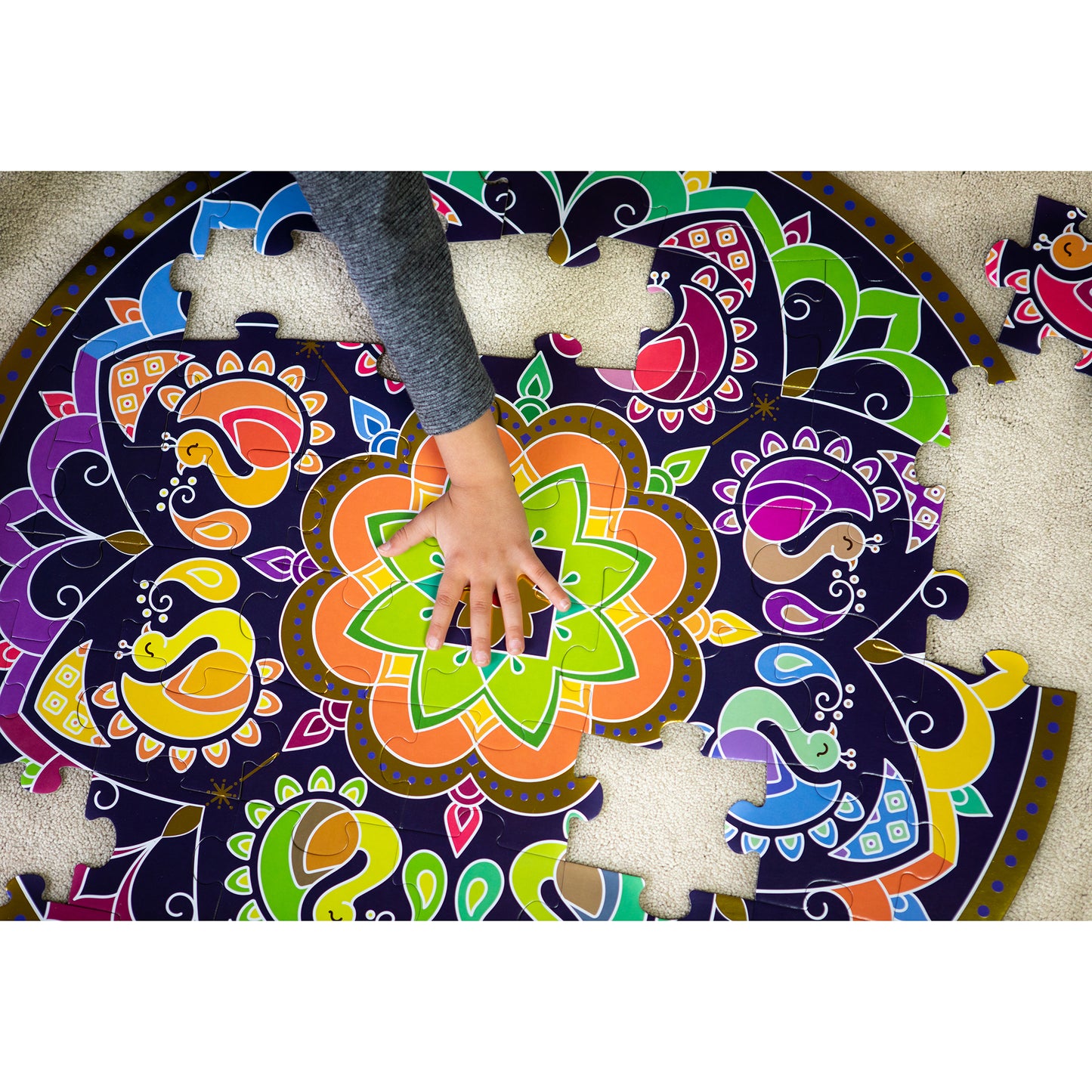 Rangoli Mandala Activity Bundle 48-piece puzzle with colorful floral patterns and child's hand placing pieces