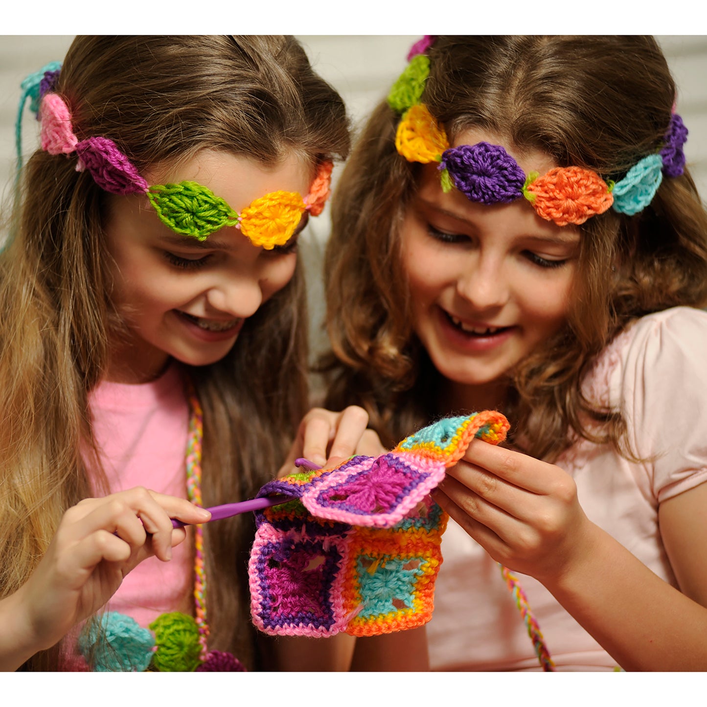 Easy-To-Do Crochet kit with colorful crocheted flowers, leaves, and accessories in pink, purple, orange, and green