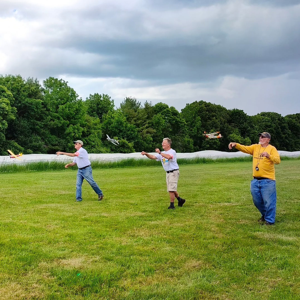 Build-N-Fly Model Kit: Fly Boy RC planes being flown outdoors by people