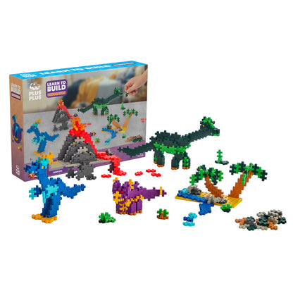 Plus-Plus Learn to Build Dinosaurs 400-piece set with colorful interlocking blocks forming dinosaurs, volcano, oasis,...