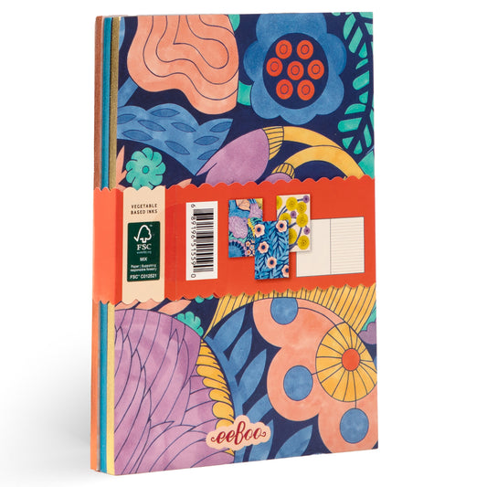 Three small hardcover notebooks with colorful floral and abstract botanical patterns in coral, blue, yellow, and pink with orange band around middle