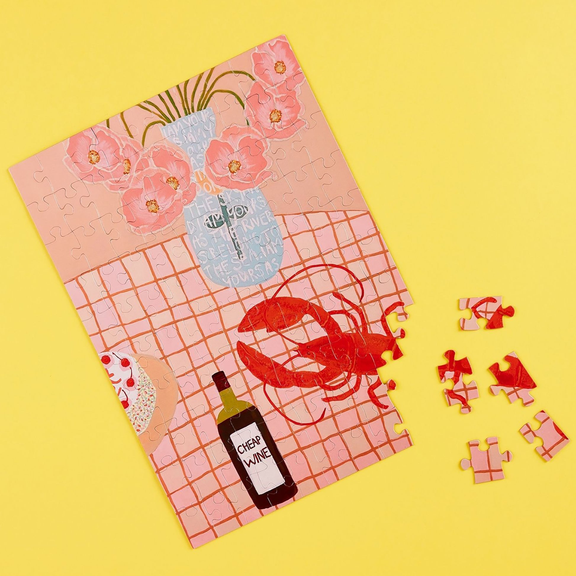 JOS Magnetic Puzzle - Lobster Lunch with pink flowers, wine bottle, and red lobster pieces on yellow background