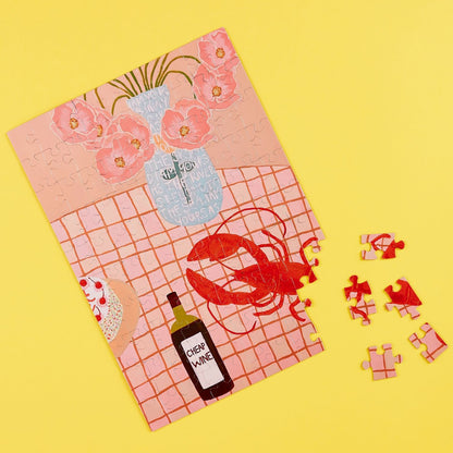 JOS Magnetic Puzzle - Lobster Lunch with pink flowers, wine bottle, and red lobster pieces on yellow background