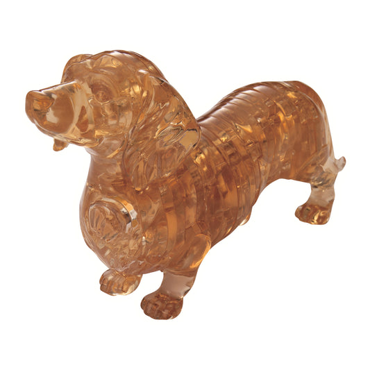 Amber translucent 3D crystal dachshund puzzle assembled on plain background