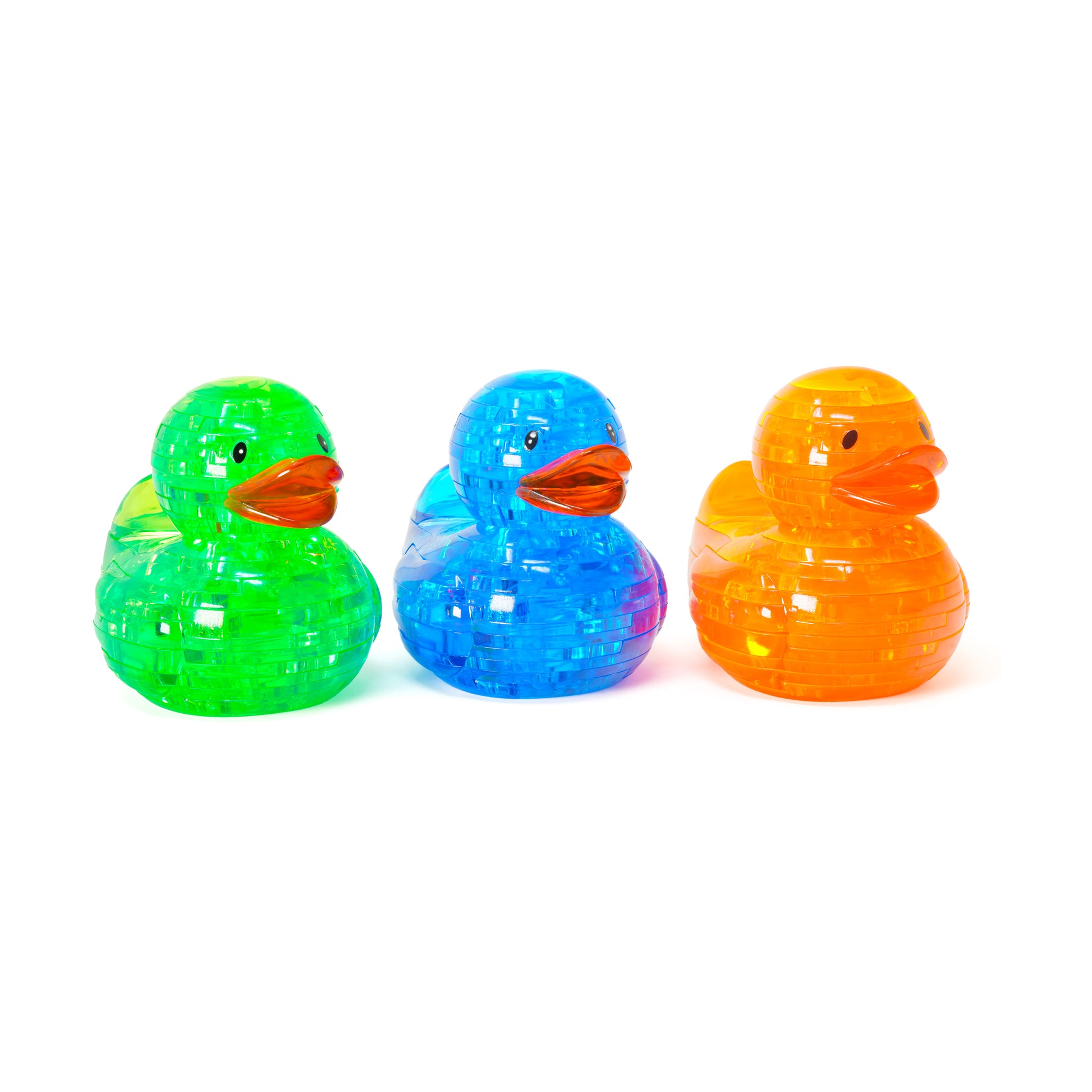 Three neon crystal puzzle ducks in bright green, blue, and orange with translucent geometric faceted bodies and red-orange beaks