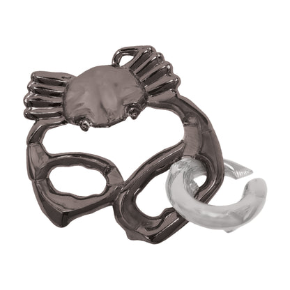 Hanayama Level 2 Cast Puzzle - Claw Challenge, metal interlocking puzzle with dark gray claw and white curved piece on plain background