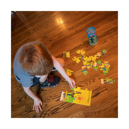 Pete the Cat Mix and Match 24-Piece Tin Puzzle with yellow and green pieces displayed on wooden floor