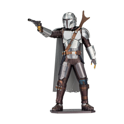 Metal Earth ICONX Star Wars The Mandalorian 3D model kit, silver and brown armored figure with helmet, blaster, cape, and detailed accessories on display stand