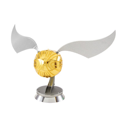 Golden Snitch 3D metal model kit with silver wings on stand, against plain background