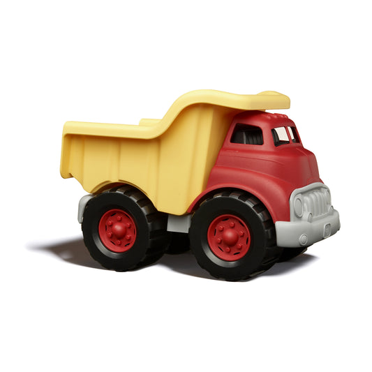 Red and yellow dump truck toy with black wheels on plain white background