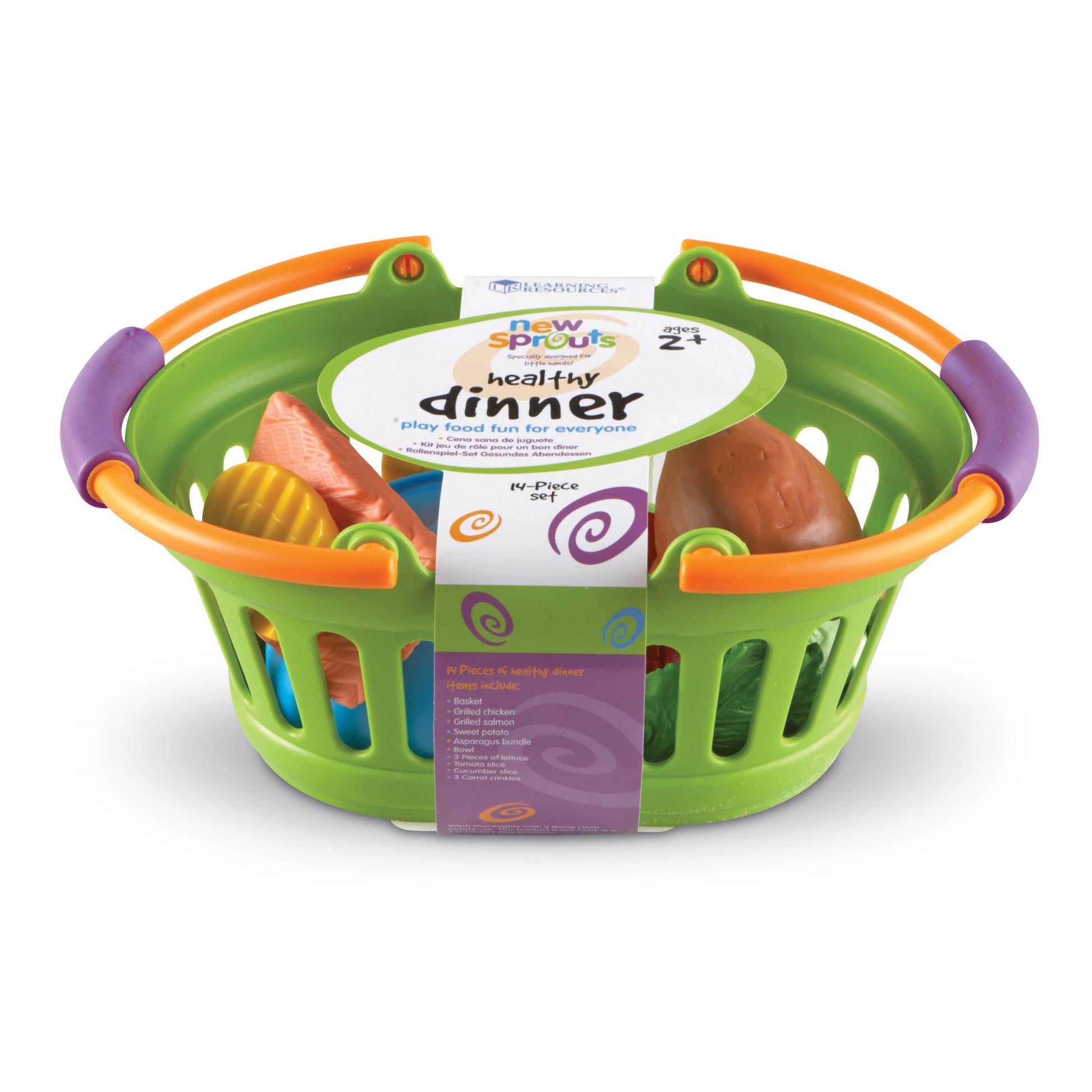 New Sprouts Healthy Dinner play food set in green basket with orange handles, including plastic salmon, chicken, sweet potato, and other food pieces