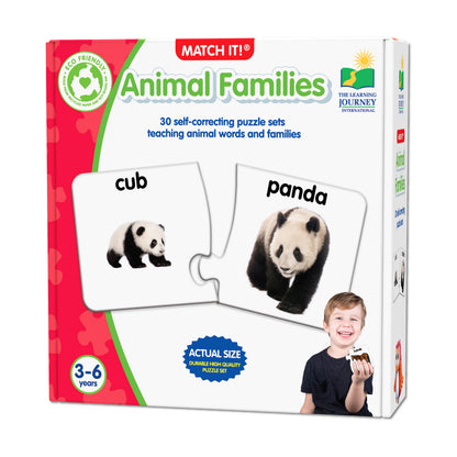 Match It! Animal Families puzzle game box showing panda cub and adult panda matching puzzle pieces, modeled by a child, for ages 3-6