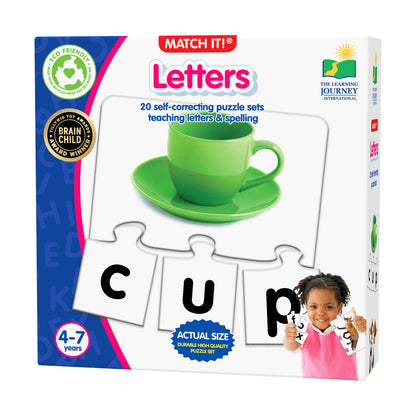 Match It! Letters puzzle game box showing green teacup image and letter puzzle pieces spelling C-U-P, modeled by a child in pink shirt, ages 4-7