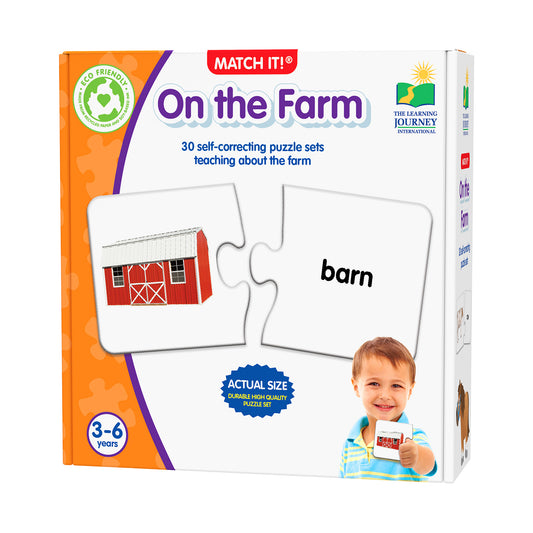 Match It! On the Farm puzzle game box showing a red barn puzzle piece matching with the word 'barn', modeled by a child aged 3-6 years