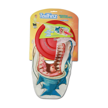 Tailfinz flying disc with red stabilizing tail and shark-shaped design, packaged on yellow and orange branded card backing