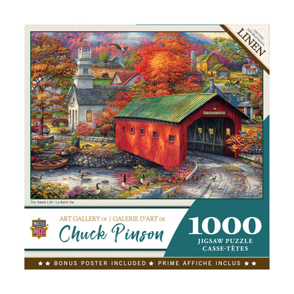 Chuck Pinson Art Gallery 1000-piece jigsaw puzzle box featuring autumn landscape with red covered bridge, white church, and farmhouses surrounded by fall foliag