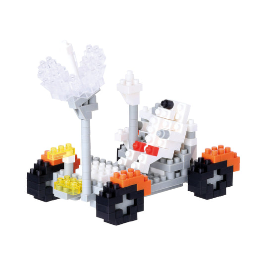 Nanoblock lunar vehicle model kit with white, orange, black, and yellow micro blocks assembled into a rover with articulated arms and treaded base