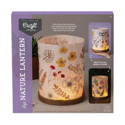 Craft Crush DIY Nature Lantern Kit packaging showing illuminated cylindrical lantern decorated with pressed flowers and leaves, with product details and glow-in