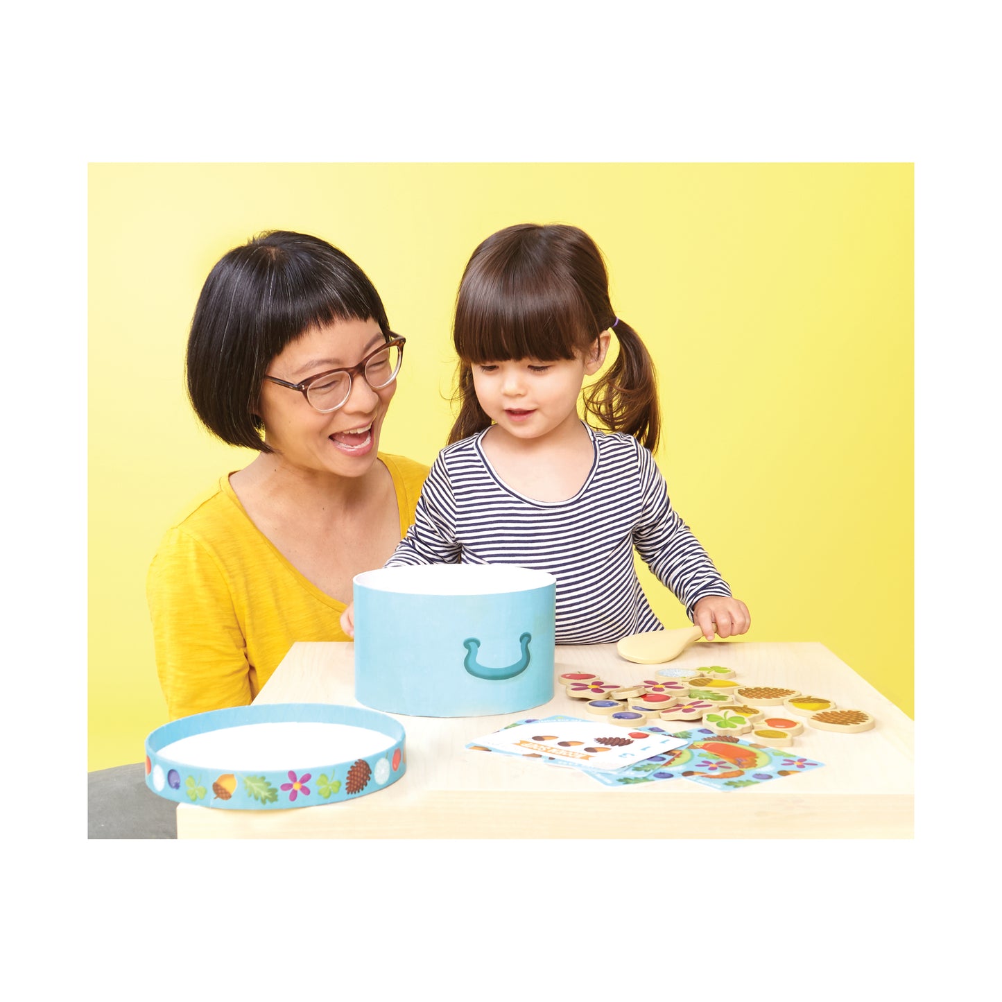 Acorn Soup toy set with blue bowl, colorful play pieces, and game cards