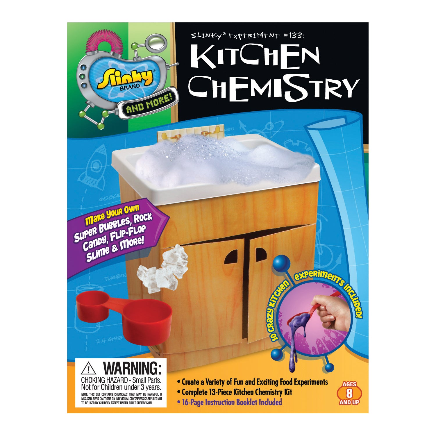 Slinky Science Kitchen Chemistry kit box showing wooden cabinet-style container with white basin top, red measuring cups, and included experiment materials for