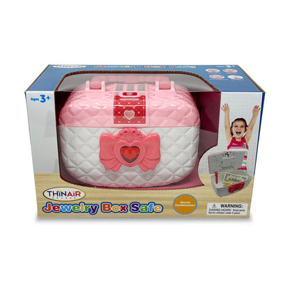 Thinair Jewelry Box Safe in pink and white with quilted design, heart-shaped latch, and red decorative bow on front, displayed in retail packaging for ages 3+