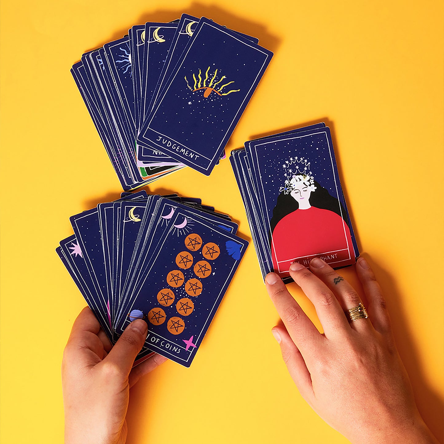 JOS Dream Tarot Cards deck with navy blue cards featuring celestial moon and sun imagery, displayed on yellow background
