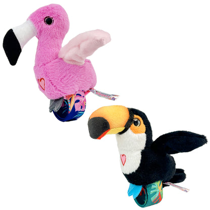 Pink flamingo and black-and-white toucan plush toys with colorful patterned feet, each with a small heart emblem