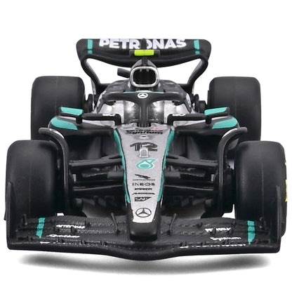 Bburago 1:64 Mercedes W16 diecast Formula racing car in black, white and turquoise with George Russell branding on di...