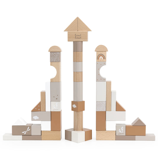 50-piece wooden building blocks in natural wood, white, tan, and gray with decorative details including clouds, rainbows, and patterns, stacked into two tall to